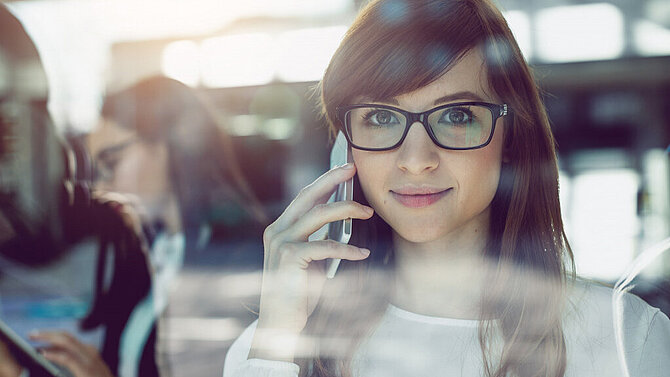 Woman smiling while talking on phone