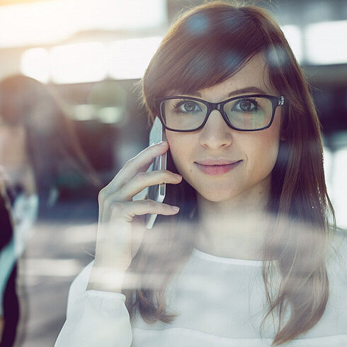Woman smiling while talking on phone 