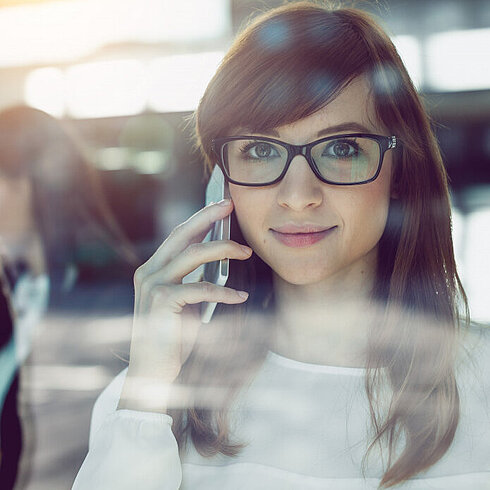 Woman smiling while talking on phone