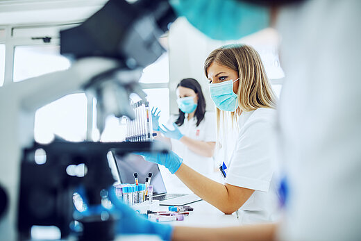 Lab workers look through the microscope 